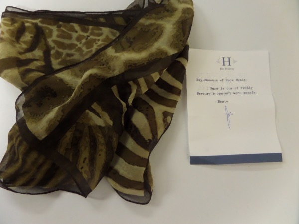 This rare rock n' roll HOF worthy item is a personal one from his buddy and colleague Jim Hutton, and has a signed note on his stationary for certainty. It is an ornately colored scarf, worn in concert by the Queen front man, and value is ? 