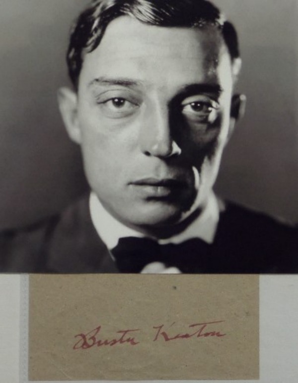 This light brown cut of paper is older and in EX overall condition.  It features the RED fountain pen ink signature of silent film comedic genius, Buster Keaton, and grades an overall 6.  Comes with a black and white photo for display, and retail from this long-deceased silver screen icon is well into the hundreds!