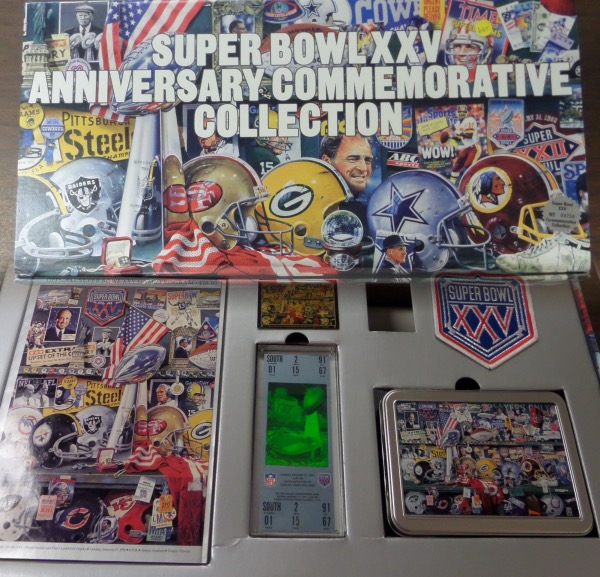 This AWESOME collector's item is numbered 4754/10,000, and is in NM condition in its colorful, original box and packaging.  It includes a game program, a Super Bowl XXV patch, replica ticket, (160) card commemorative set in a collector's tin, a hat, a collector's pin, and a Merv Corning commemorative poster.  A wonderful Super Bowl collector's memento, valued well into the hundreds!