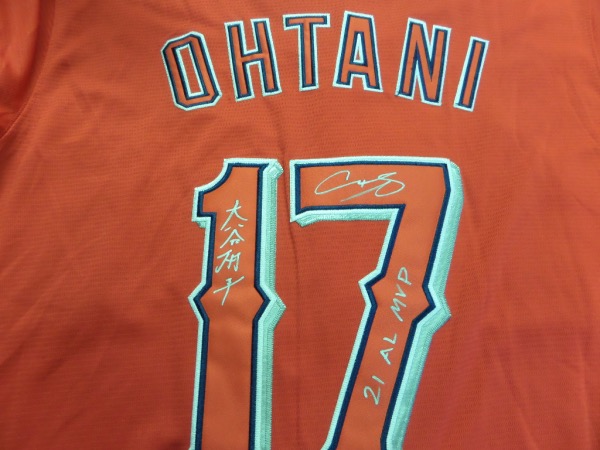 This red size L Angels #17 Ohtani jersey from Nike still has original tagging attached, and is in NEW condition, with everything hand-sewn.  It is back number-signed in bright silver by the eventual AL MVP himself, written in both English and Japanese, and topped off with a 21 AL MVP inscription, grading an 8 at least.  A great looking jersey, and retail is high hundreds right now at least!