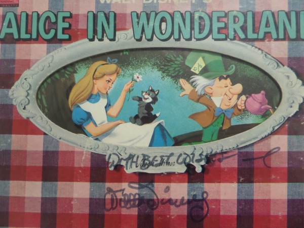 This vintage "Alice In Wonderland" LP album is from 1962 and looks just great.  It is hand-signed in black felt tip marker by none other than Walt Disney himself, grading about a 6.5 overall, a truly fine example of a Disney autograph, and still shows up well against the yellow part of the album cover, and the album includes a photo COA from Super Sports Stars & Memorabilia.  With his death now more than a half century ago, retail here is very high hundreds!