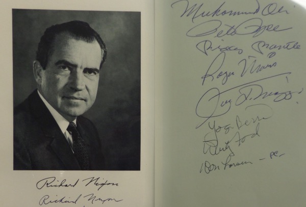 This 6.25x8 black and white photo is an image of 37th US President, Richard Nixon, featuring both facsimile and actual autographs on the front.  It is also hand-signed on the back by 8 different iconic athletes, including Muhammad Ali, Pete Rose, Mickey Mantle, Roger Maris, Joe DiMaggio, Yogi Berra, Whitey Ford and Don Larsen.  Eight of the nine signers on here are no longer living, and this baby absolutely BEGS for a double sided frame!