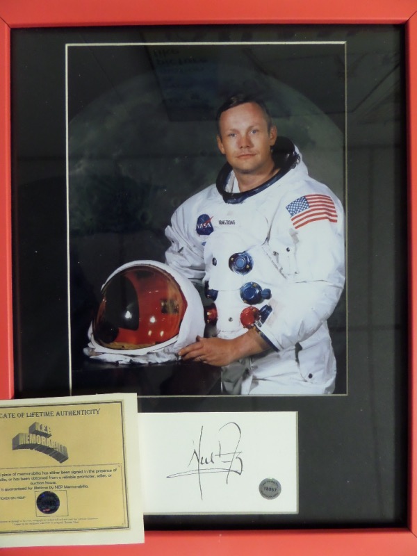 This 12x15 red-framed and black-matted display features a color photo of Neil Armstrong posing in his NASA space suit.  Beneath the photo is a cut, hand-signed in black ink by the First Man on the Moon himself.  The piece includes a COA from N.E.P. Memorabilia, and is 100% ready for display!