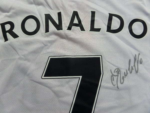 This white AIG Manchester United soccer jersey is still like NEW, and comes hand-signed in black sharpie by one of the game's elite players, Cristiano Ronaldo!  This is a fine-looking signature, grading a legible 8, from one of the harder gets in the autographing world, and the jersey values well into the hundreds!!!