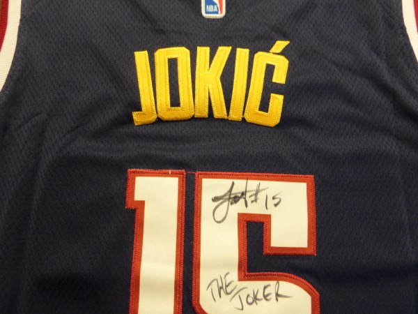This mint dark blue Nuggets jersey is authentic and trimmed in white and gold! It comes signed by this mega-talented big man in blue on his back numbers with #15 and THE JOKER included by Nikola!  He is 1 of the best players in the World and a favorite for NBA MVP again! Nuggets just won it all so retail skyrocketing!