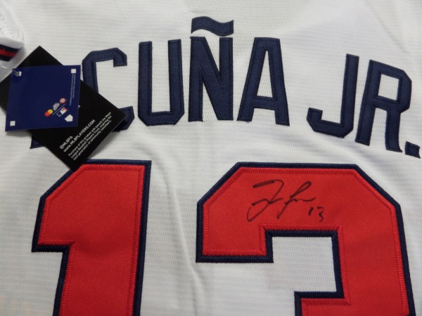 This mint, authentic-style home white Braves jersey has sewn on everything and comes signed on the back numbers by this young superstar!  He is a top 3 talent in the league and has included his #13 with his signature in black.  Guaranteed authentic and retail is going up and up as they are favorites to win it all this year. 