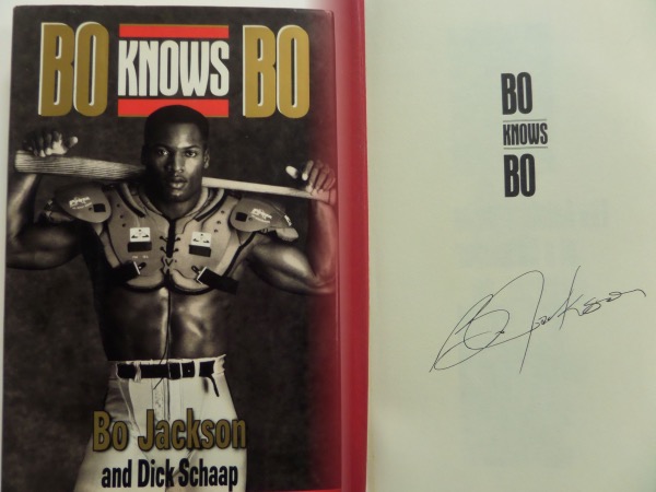 This original 1990 "Bo Knows Bo" by Dick Schaap hardbound book is still in NM condition, with its dust jacket completely intact.  It is hand-signed in black ink on the inner title page by the supreme athlete himself.  The signature grades about an 8, and looks just fabulous.  A wonderful sports collector's item, and retail is well into the hundreds!