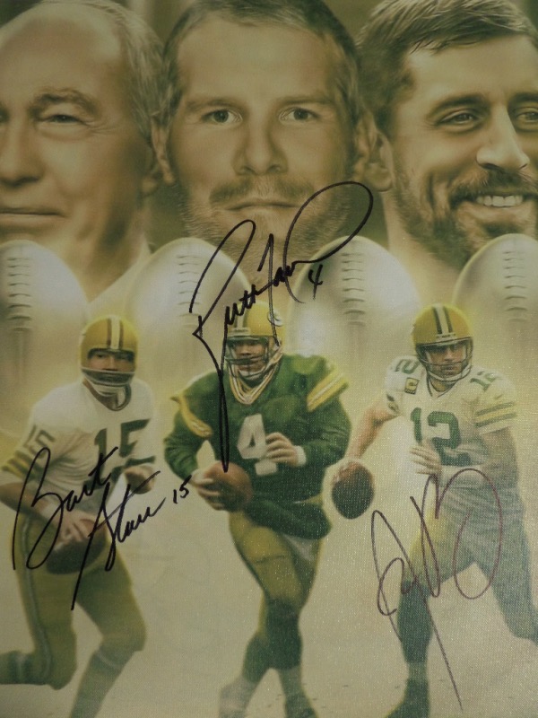 This real canvas work is a gem, shows Bart Starr, Brett Fave and Aaron Rodgers, and comes boldly signed by all 3 on terrific spots. It grades a clean bold 10 all over, measures a whopping 20x24 in size, and value is over two grand for sure. 