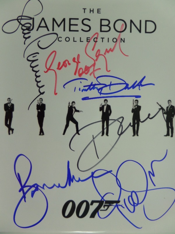 This "James Bond Collection 007" logo B&W photo print comes autographed in red, blue and black sharpie by all six actors who have portrayed the super spy in film.  Included are Sean Connery, George Lazenby, Roger Moore, Timothy Dalton, Pierce Brosnan and Daniel Craig.  A great looking piece, with beautiful signatures, each grading 9 or better, and valued into the mid hundreds!