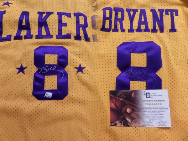 This yellow 4XL Length+2 custom LA Lakers #8 Bryant jersey is trimmed in purple and still in NM condition.  It is hand-signed in silver sharpie by the Mamba himself, not just on the back number--grading a light 5--but also on the front number as well--grading an 8.5.  Fully certified by Global Authentication Inc (GV176802), and valued well into the thousands since Kobe's 2020 death!