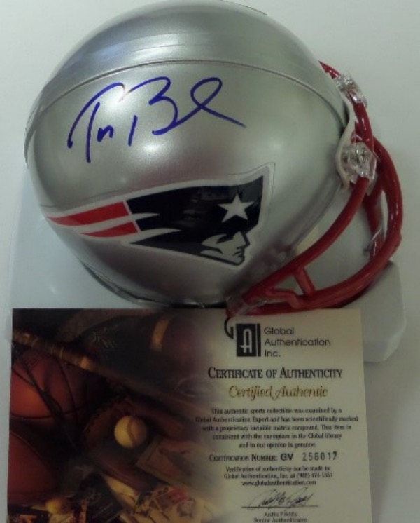 This silver New England Patriots throwback mini football helmet from Riddell is boxed in NM/MT condition, and comes hand-signed in blue sharpie by their all World QB and sure-fire future HOF'er, Tom Brady.  The signature grades a clean 8.5-9, and the helmet is furnished with a Global Authentication Inc. COA (GV256017) for your assurance.  Valued into the very high hundreds!