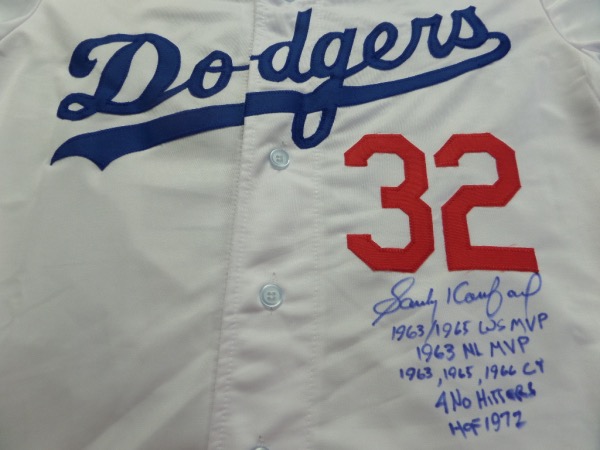This size L home white 1955 Brooklyn Dodgers custom throwback jersey is trimmed in red and blue with everything sewn on, and comes front signed in blue sharpie by the great 3 time Cy Young Award Winner and HOF lefty!  The signature grades a legible 8.5, includes 4 No Hitters, 1963, 1965, 1966 Cy, HOF 1972, 1963/1965 WS MVP and 1963 NL MVP inscriptions, and will show off brilliantly in any baseball collection!