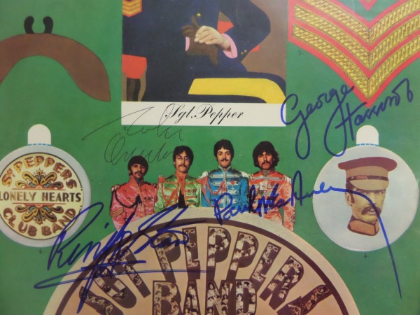 This roughly 12x12 inner album sleeve insert for the '67 classic, "Sgt. Pepper's Lonely Hearts Club Band" was a hit with fans of the band, as it contained cutouts for collectors.  This one, however, is completely intact, in EX/MT condition, and actually comes hand-signed by the band, with George, Paul and Ringo in blue, and John in black ink.  Ready to frame and display, and MUCH more unique than the signed album!