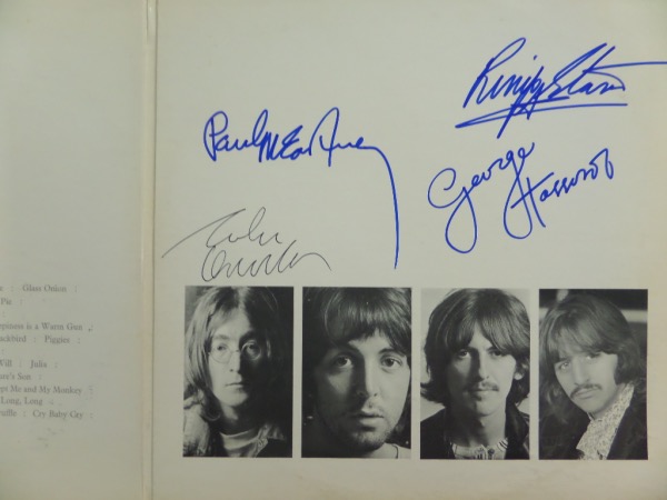 This amazingly unique collector's item is original 1968 Beatles "White Album," in VG+ shape, and numbered A2130288 on the front.  It is hand-signed on the inside--please see our attached photo--with Paul, George and Ringo in blue sharpie and John in black ink!  Most here grade 8's or better, and are very bold and legible.  Any album signed by all four these days is worth a small fortune, and this one, signed on the inside over there images, might be considered even more unique!