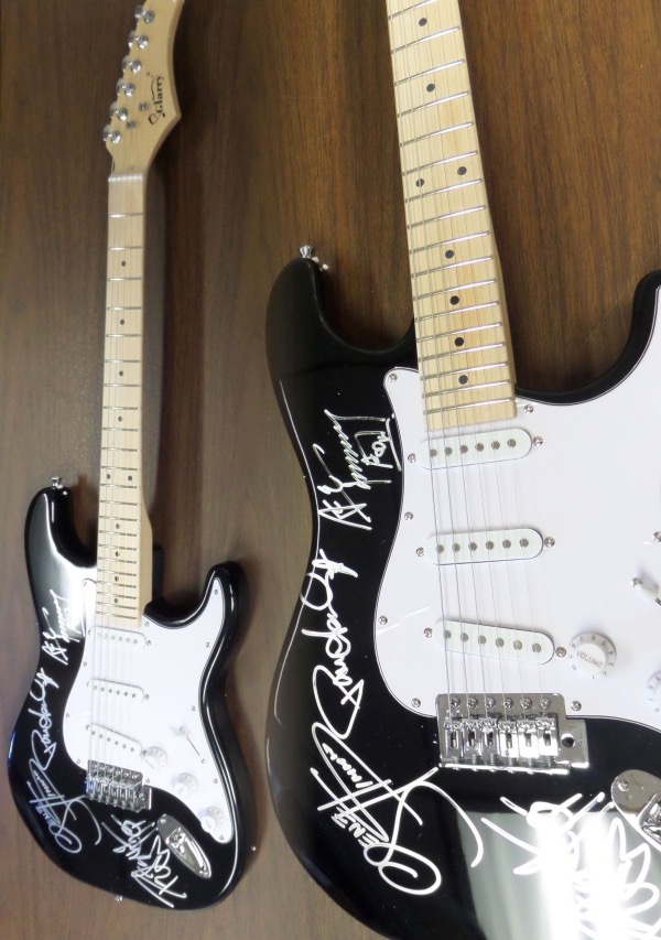 This black "statocaster style" guitar is in store bought condition, and comes brilliantly body signed in silver paint pen by all four members of this iconic '70's hard rock hit machine band!  Included are Gene Simmons, Peter Criss, Paul Stanley and Ace Frehley, with the signatures grading legible 8's or better, and this guitar will show off spectacularly in any rock music collection!