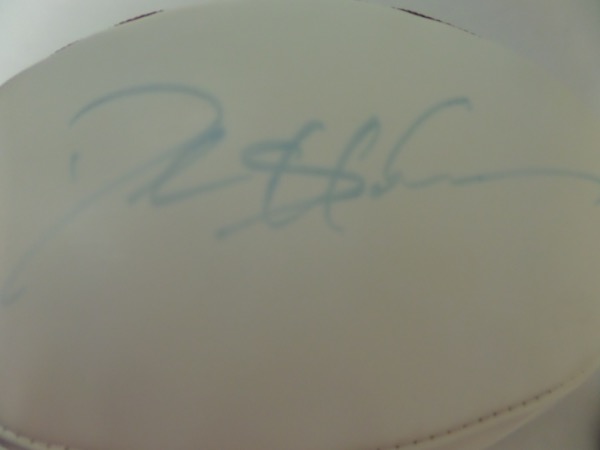 This full size, triple white panel football from Wilson is still NEW with original tagging attached, and comes hand-signed in blue felt marker by the greatest cover corner in NFL history, Deion Sanders.  The signature is a tad light, grading about a 5-6, and the ball is affixed with a sticker from PSA/DNA (T23918) for authenticity purposes.  Valued into the high hundreds!