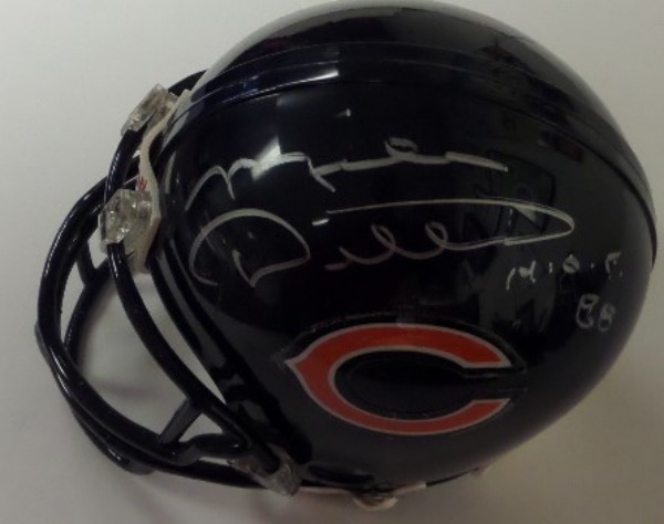 This Chicago Bears mini football helmet from Riddell is boxed in NM condition, and comes hand-signed in silver by one of their true all time greats, HOF tight end and SB winning Coach, Mike Ditka.  The signature grades about an 8, complete with a H.O.F. 88 inscription, and the helmet is affixed with a hologram sticker from Beckett (BJ060442) for absolute authenticity.  Valued well into the mid/high hundreds!