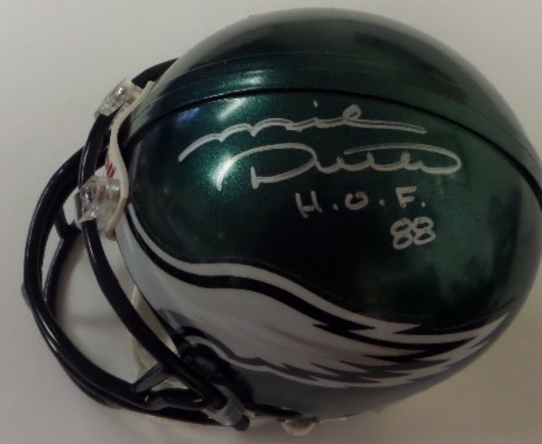 This green Philadelphia Eagles mini football helmet from Riddell is boxed in NM condition, and comes hand-signed in silver by HOF tight end, Mike Ditka.  The signature grades about an 8.5, complete with a H.O.F. 88 inscription, and the helmet is affixed with a hologram sticker from Beckett (BJ060443) for absolute authenticity.  Valued well into the mid/high hundreds!