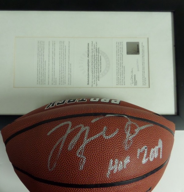 This new Spalding leather ball comes whole panel signed by Jordan in large, bold silver paint pen, and with "HOF 2009" written as a bonus. The high value autograph is a 9, shows off EZ from 40 feet away, and comes with a framed Upper Deck COA from his 2011 Flight School Camp. NO hologram remains, you just get the real lifetime numbered full cert labeled as a "basketball"..