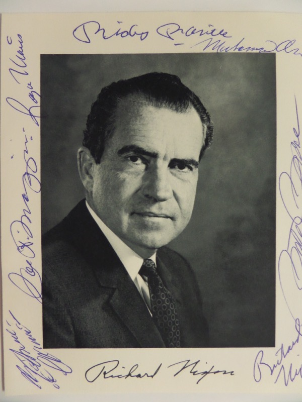 This 6.25x8 black and white photo is an image of 37th US President, Richard Nixon, featuring both facsimile and actual autographs on the front.  It is also hand-signed on the front, all around, by 6 different iconic athletes, including Muhammad Ali, Pete Rose, Mickey Mantle, Roger Maris, Joe DiMaggio, and Roberto Clemente.  Six of the seven signers on here are no longer living, and this baby absolutely BEGS for a double sided frame!