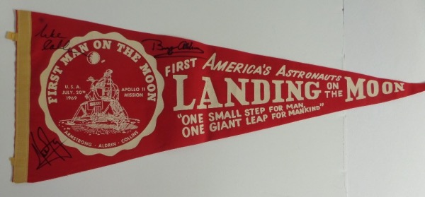 This 29" long "America's Astronauts Landing on the Moon" red pennant is still in NM condition overall, with an Apollo 11 logo and Armstrong quote.  It is hand-signed in bold, clean black sharpie by all three, including Neil Armstong, Buzz Aldrin and Michael Collins, and retail on this gem is easily into the low thousands!