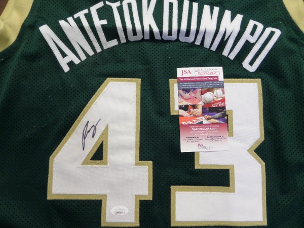 This top notch NBA future HOF investment piece is a custom jersey, has name on back, and comes hand signed by the "Greek Freak" in large, bold black sharpie. It grades as good as it gets, was witnessed signed by JSA himself, and value is sky high on the legendary Milwaukee Stud. 