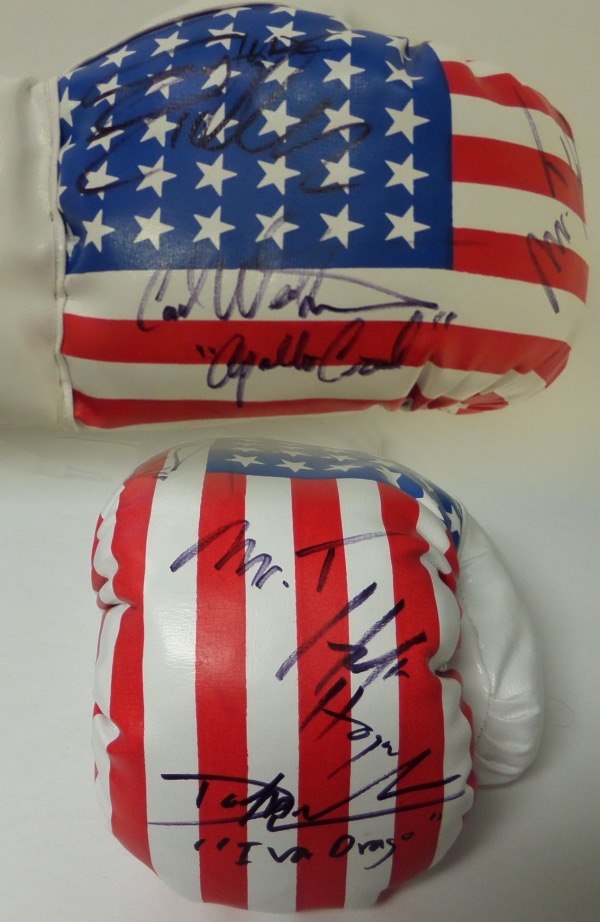 This unique item is a mint USA flag 14 oz. boxing glove that comes signed wonderfully in black sharpie by 5 stars from the legendary Rocky movie and sequels. Included are Sylvester Stallone and 4 of his opponents over the years. Included are Carl Weathers, Mr.T, Dolph Lundgren, & Hulk Hogan!!  A MUST for the boxing fan and even some of their character names included by the legends!
