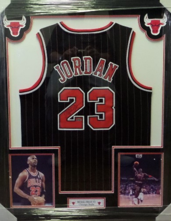 This spectacular display is 3x4 FEET in size, and comes custom triple matted in red, black and white Bulls team colors. It has 4 custom cutouts, but the main piece is an INPerson Authentics hologrammed 1997 game jersey from Jordan. It is signed in bold black sharpie, has Lee's added ok for certainty, and shows off well from a football field away!  Great investment chance, and we'll guess value at $12,000 after PRO framing.