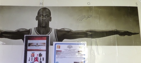 This huge 6-foot wide 1990's Nike poster literally shows Jordans wingspan with his arms, and comes IN PERSON signed in bold black sharpie. It comes with a full LOA from Iconic and comes dry mounted to you on hard board. It has a center crease and all sorts of other dings, dents and creases from shipping damage. Its real, but its not mint!