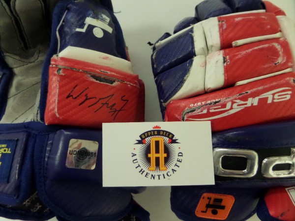 This museum worthy lot is a pair of well used Edmonton Oilers hockey gloves from the "Great One", and done in red, white and blue team colors. They are his pro leather gloves, one comes black marker signed by Gretzky, and a UDA hologram accompanies for certainty. Solid sports buy and hold  investment, and value is priceless. 