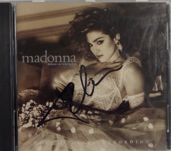 This CD version of what is still Madonna's most well-known album, "Like a Virgin," is still in EX+ condition overall, and comes hand-signed on the inner booklet by Madonna herself.  The signature is in black sharpie, grading a legible 8.5-9, and retail on this collector's GEM is mid hundreds!