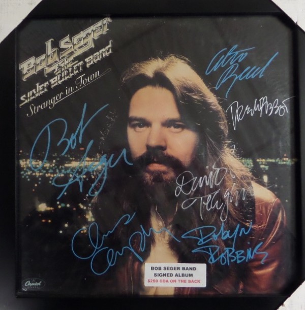 This #1 hit LP is "Stranger in Town", shows the HOF rocker in color on the cover, and comes silver paint pen signed by almost 10 band mates, plus him! It is a clean bold 10 all over the place, EZ on the eyes from 20 feet away, and comes framed in black wood for easy show off. 