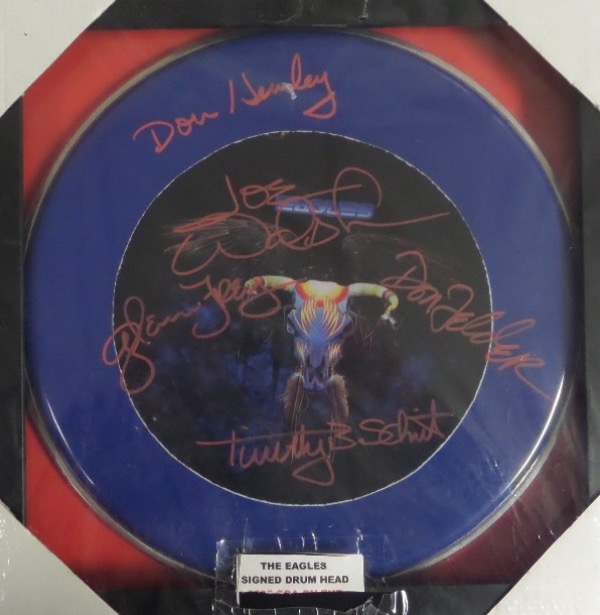 This superb piece or rock n' roll memorabilia is a real drum head, has a color album photo incorporated into it, and comes red paint pen signed by all 5 original rock stars. Of course Glenn Frey, Joe Walsh and Don Henley are here, and value after custom matting and framing might be $1500.00.