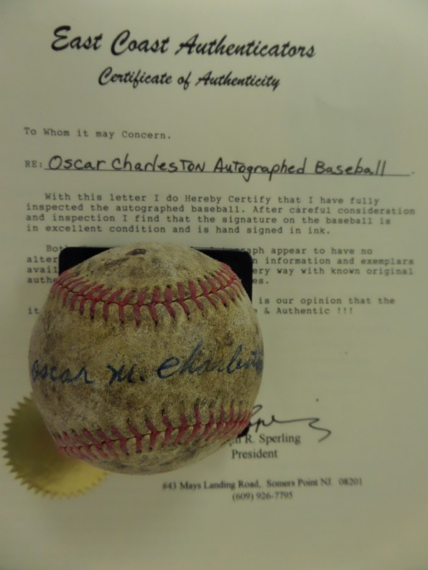This vintage, red-laced, unmarked baseball is in P/F condition, and comes hand-signed across the sweet spot in blue by legendary Negro League HOF'er, Oscar Charleston.  The signature grades a legible 5 overall, comes certified by East Coast Authenticators, and the ball is valued at $15,000!!!