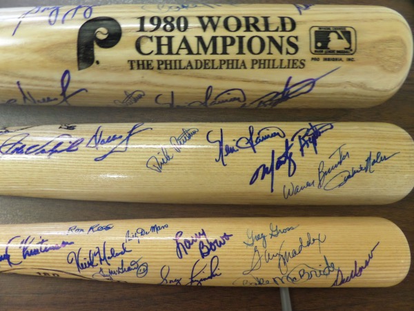 If you're a Phillies fan or collector, then you simply HAVE TO get in on this rarity.  It is a MINT Louisville Slugger blonde bat with the Phillies logo and 1980 WORLD CHAMPIONS engraved into the barrel.  It is hand-signed in blue sharpie by 17 members of this first time WS winning ballclub, including Manager Dallas Green (dec), WS hero Tug McGraw (dec), Greg Luzinski, Larry Christenson, Larry Bowa, Ron Reed, Garry Maddox, Greg Gross, Del Unser, Bake McBride, Keith Moreland, Billy DeMars (dec), Dick Ruthven, John Vukovich (dec), Kevin Saucier, Marty Bystrom, Dickie Noles and Warren Brustar.  Really, you're only missing Schmidt, Carlton and Rose, and all three are still alive, so they can easily be gotten, and probably for a reasonable price.  This is a beautiful bat, and a requirement for the serious Phillies fan!