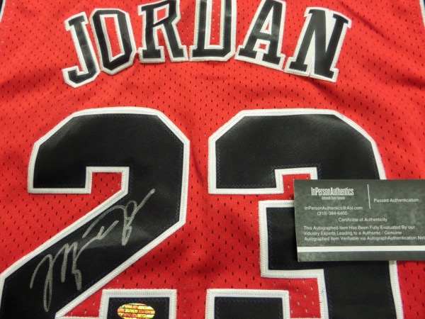 This mint Chicago road red is trimmed in black and white team colors, has sewn on everything as well as name on back, and comes tagged from that magical 1997-98 NBA season. It comes back #23 signed by the best ever in stunning silver paint pen, shows off well from 25 feet away, and even has the InPerson Authentics lifetime COA and added hologram for lifetime certainty. 