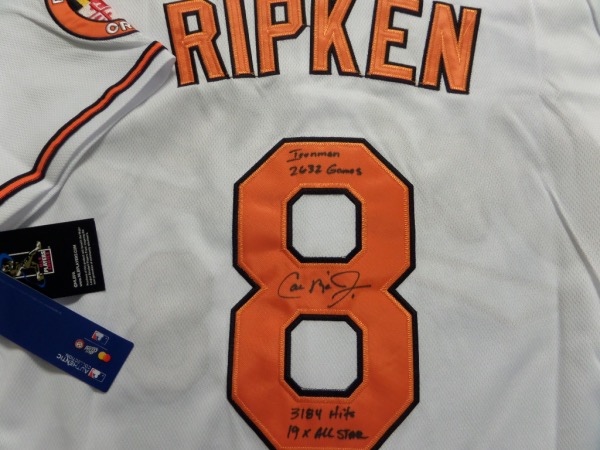 This home white size 44 O's jersey from Nike is still new with tags, and comes trimmed in black and orange, with everything sewn.  It comes hand-signed on the back number in black sharpie by the HOF ss/3b himself, grading a legible 8, and including 19X All Star, 3184 Hits, "Ironman", 2632 Games.  AWESOME and unique, and super cool!