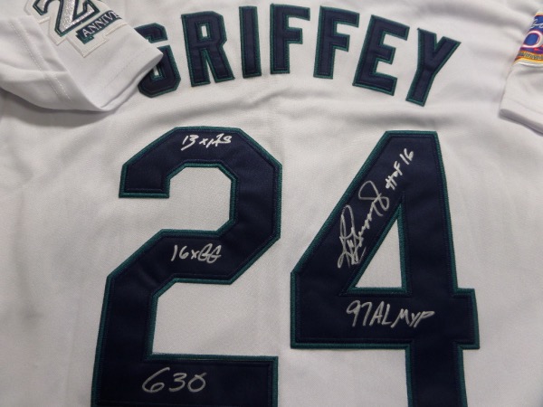 This home white size L Seattle Mariners jersey is trimmed in green, blue and silver, and comes with everything professionally hand-stitched.  It is back number-signed in bright silver on the back number by the HOF great himself, including 16X GG, HOF 16, 13X AS, 630, and 97 AL MVP inscriptions.  A super duper unique collector's item, and retail is very high hundreds!