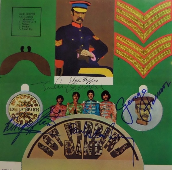 This roughly 12x12 inner album sleeve insert for the '67 classic, "Sgt. Pepper's Lonely Hearts Club Band" was a hit with fans of the band, as it contained cutouts for collectors.  This one, however, is completely intact, in EX/MT condition, and actually comes hand-signed by the band, with George, Paul and Ringo in blue sharpie, and John in black ink.  Ready to frame and display, and MUCH more unique than the signed album!