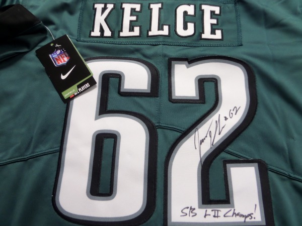This green size L Eagles jersey from Nike is still tagged as new, and has everything professionally-sewn.  It is back number-signed in black sharpie by one of the most popular players in franchise history, and yes, he's a CENTER!  Of course, we're talking about future HOF'er Jason Kelce, and he has signed this one beautifully in black sharpie, grading a 9, with #62 and SB LII Champs! inscription!  Valued into the mid/high hundreds1