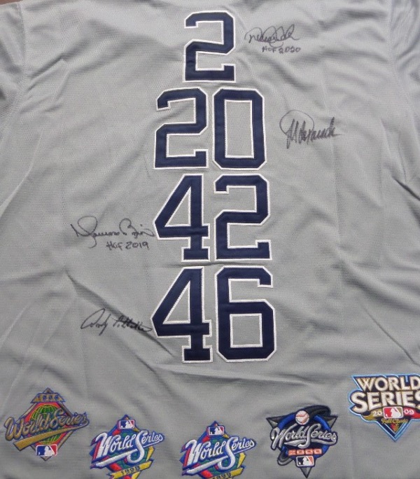 This amazing team item is custom made, a road gray NYY jersey from M&N with FOUR sewn on numbers on back, and with FIVE colorful World Series patches at the bottom. It honors all 4 NY Yankees greats and future HOF'ers, Rivera, Jeter, Pettitte and Posada, and comes black sharpie signed by everyone. It is a true must have, value has to be almost 2 grand after custom tailoring, and show off is easy to do from across our auction room-amazing!!! 