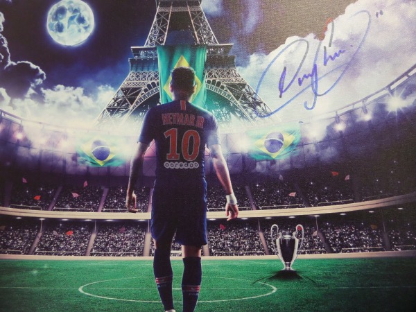 This 18x22 canvas has a full color original litho print screened--an image of soccer star Neymar Jr, walking on a pitch, with the Eiffel Tower in the background.  It features a beautiful blue sharpie signature from the World Futbol superstar himself, and will make for a wonderful addition to any soccer collection.  Valued well into the hundreds!