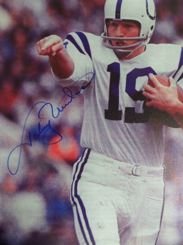 This well done pro giclee is real canvas, about 18x22 in size, and very colorful. It shows the NFL HOF star QB in action, comes hand signed in large, bold blue marker, and grades a decent 8 overall. It is a must frame, value is sky high on this high quality artwork, and it is a great show off piece, suitable for any collection. 