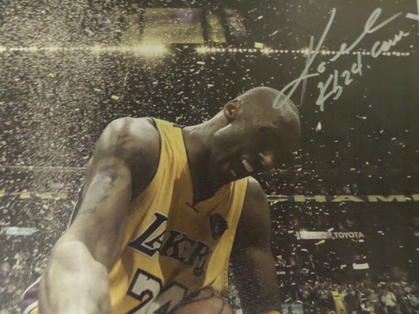 This full color photo print is done on an actual canvas, measuring 18x22, and in NM/MT condition.  It is an image of Kobe Bryant celebrating a win with the Lakers--probably one of his 5 championships--and comes hand-signed in silver by the all time NBA great himself.  With his death now just short of 4 years ago, retail is low thousands!