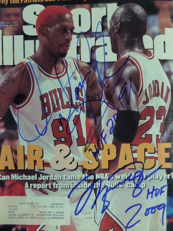 This October 23, 1995 full issue of SI is in EXMT condition, with a color image of Jordan talking to a red-haired Rodman in the early part of their '96 NBA Title run.  It is blue sharpie-signed by both, with each adding his HOF year to his signature, and this piece will look amazing when framed for display.  Valued into the low thousands!