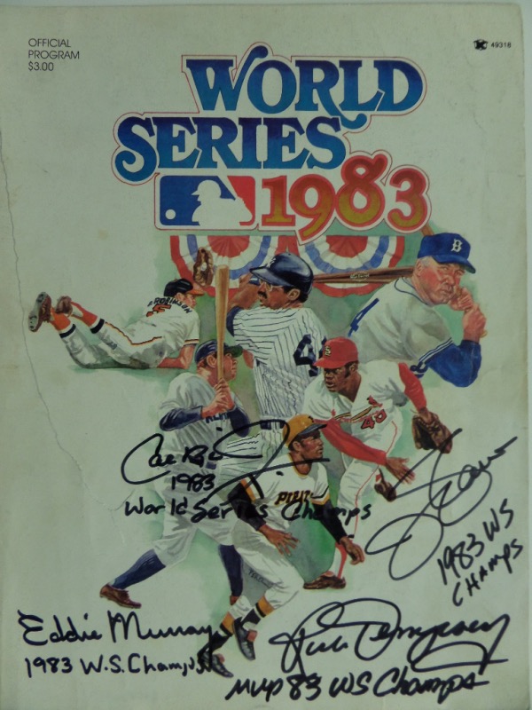 This full program for the 1983 World Series is in VG shape with a slight tear on the front cover, but it will frame and display with ease.  It is hand-signed on the front cover in black sharpie by four key members of that team, including HOF'ers Ripken, Murray and Palmer, as well as WS MVP Rick Dempsey, and each has added an inscription to boot!  Valued into the mid/high hundreds!