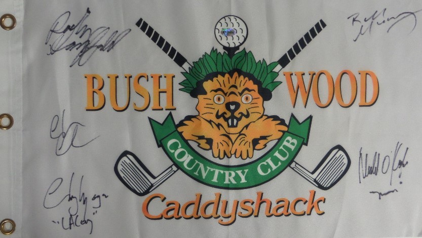 This white "Bushwood Country Club" pin flag from the movie Caddyshack has been black marker signed by 5 cast members, including Chevy Chase, Bill Murray, Michael O'Keefe, Cindy Morgan, and the late Rodney Dangerfield.  All signatures grade 9's or better on this piece that is a must have for fans of the classic comedy, and values into the high hundreds and nice!