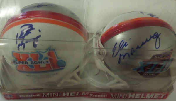 This custom, specially made mini is from Riddell and has TWO different Super Bowl logos. One is from the 2007 Miami held Super Bowl XLI where Peyton's Colts won, the other is from 2008 in Arizona where Eli's Giants won. Each side comes hand signed by the appropriate Manning Brother, and in bold, clean blue sharpie. Valued into the high hundreds!