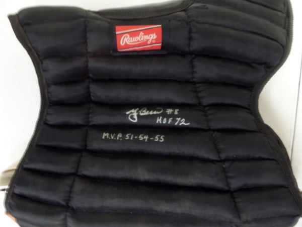 This black catcher's chest protector from Rawlings is still in NM condition, and comes hand-signed in silver by one of the great catchers to ever play the game, 3 time AL MVP and HOF Yankees receiver, Yogi Berra.  The signature grades a legible 8.5, complete with #8, HOF 72 and MVP 51-54-55 inscriptions, and retail from this deceased all time great is low thousands!