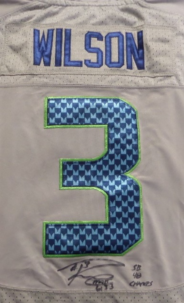 This gray size 44 Seattle Seahawks jersey from Nike is in NM condition, and comes with everything professionally-stitched.  It is hand-signed beneath the back number in black sharpie by the only QB to take the team to the promised land, Russell Wilson.  The signature grades an overall 8-8.5, complete w/ a SB 48 CHAMPS inscription, and retail is high hundreds!